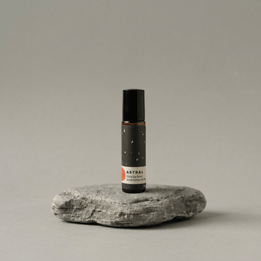 Roll-up bottle labeled 'Astral' on a gray stone surface with a neutral background
