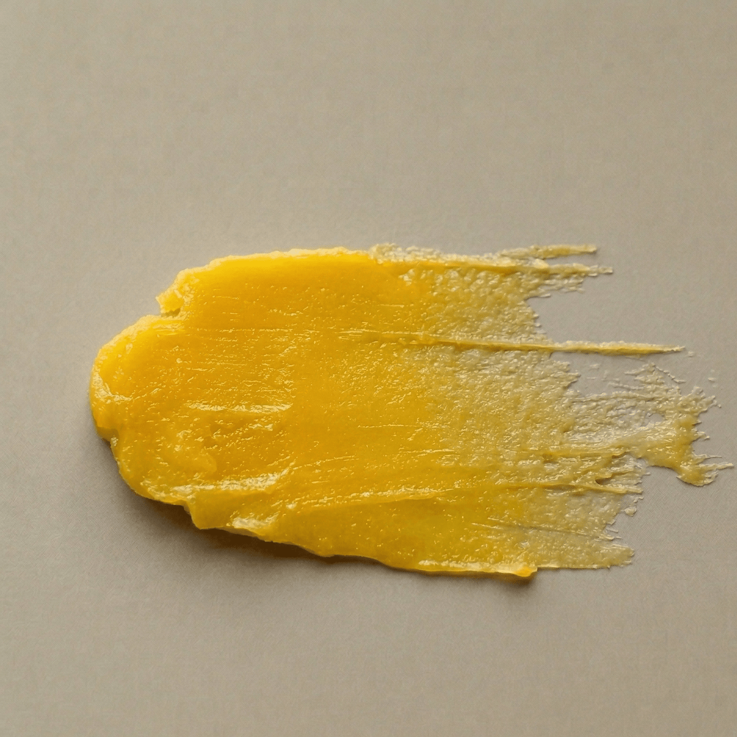 Aurora cleansing balm texture — rich golden balm that melts into a nourishing oil on contact