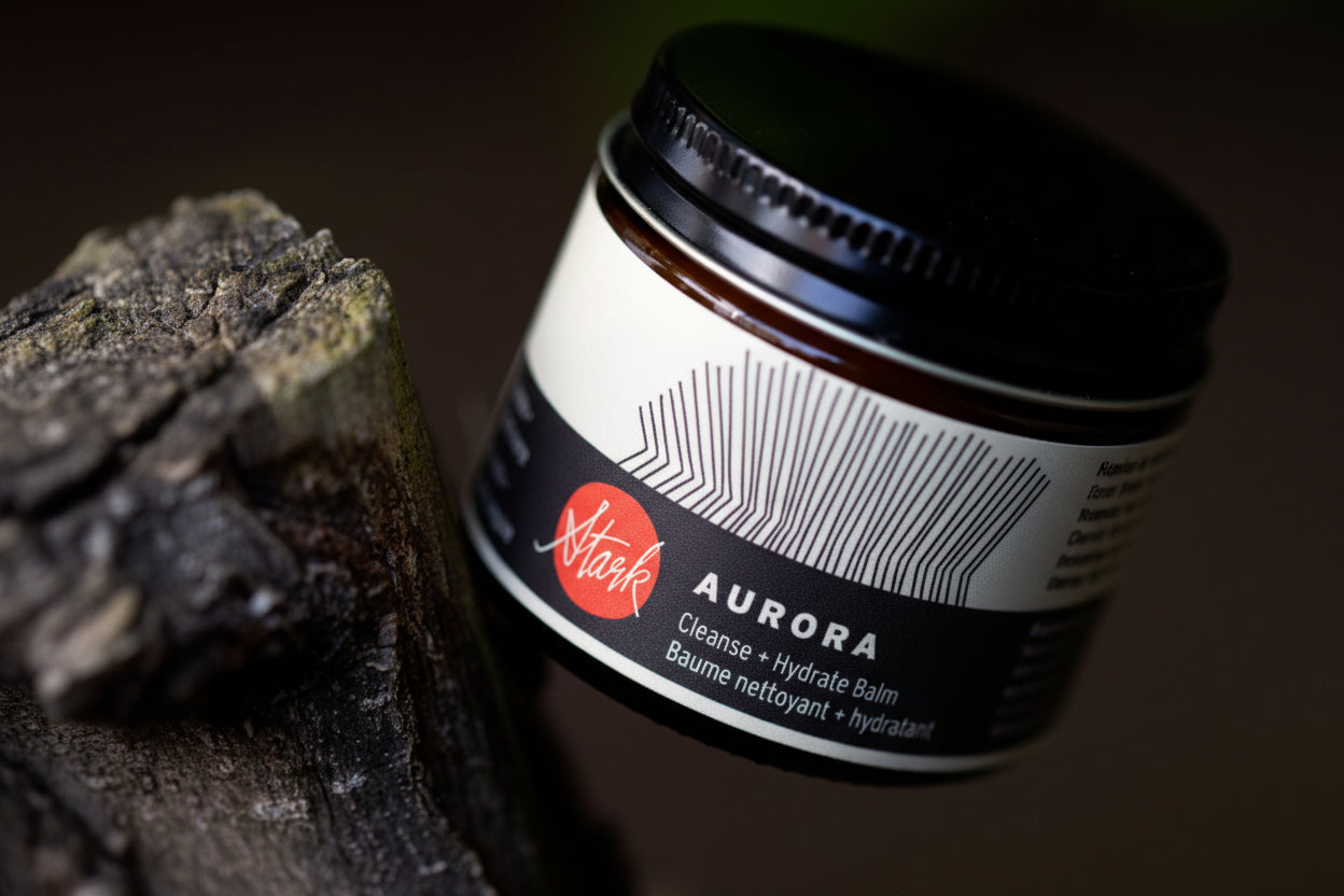 Bottle of Stark Aurora balm with a dark background