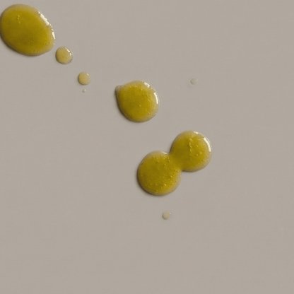 City vitamin C oil serum texture — lightweight green-tinged oil that absorbs quickly under sunscreen
